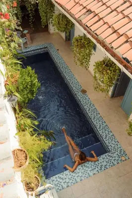 a woman laying in a swimming pool at Casa Heredia Boutique in Cartagena de Indias