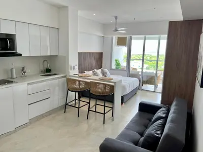 a kitchen and living room with a bed and a couch at cartagena beach resort in Cartagena de Indias