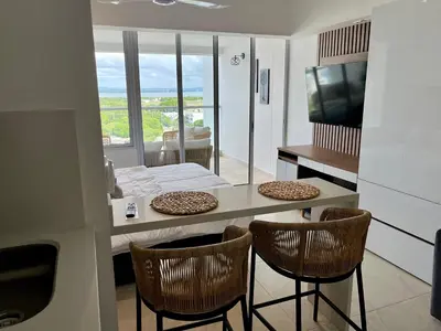 a kitchen with a table and chairs and a television at cartagena beach resort in Cartagena de Indias