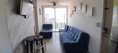 a living room with a blue couch and two chairs at 406 Sea Breeze and Luxury in Cartagena in Cartagena de Indias