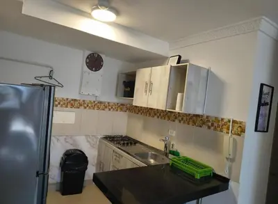 a small kitchen with a sink and a refrigerator at Piso 2206 Mirador de Cartagena in Cartagena de Indias