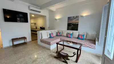 a living room with a couch and a table at Casa Miramar by Soho in Cartagena de Indias