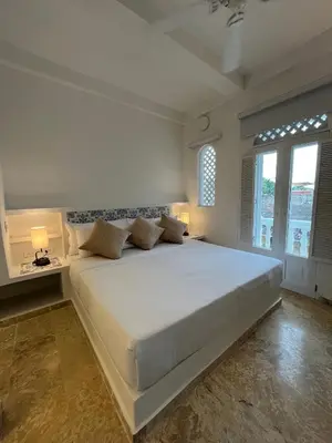 a large white bedroom with a large white bed at Casa Miramar by Soho in Cartagena de Indias