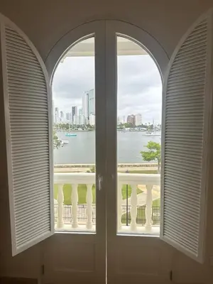 an arched window with a view of the water at Casa Miramar by Soho in Cartagena de Indias