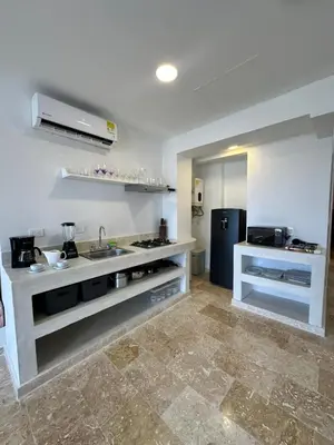 a large kitchen with a sink and a refrigerator at Casa Miramar by Soho in Cartagena de Indias