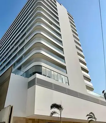 a tall building with palm trees in front of it at CARTAGENA BEACHT - APARTAESTUDIO A 100 mt del mar - Piscina, Jacuzzi in Cartagena de Indias