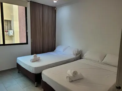 two beds in a room with towels on them at Apto en EL Cabrero, Edificio Manzanillo del Mar in Cartagena de Indias