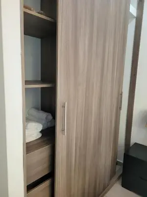 a closet with a wooden door in a room at Apto en EL Cabrero, Edificio Manzanillo del Mar in Cartagena de Indias