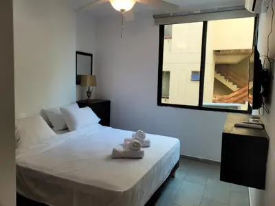 a bedroom with a bed with two towels on it at Apto en EL Cabrero, Edificio Manzanillo del Mar in Cartagena de Indias