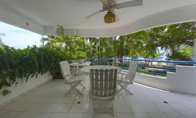 a patio with a table and chairs on a balcony at Great Apartment With Private Pool in Cartagena de Indias