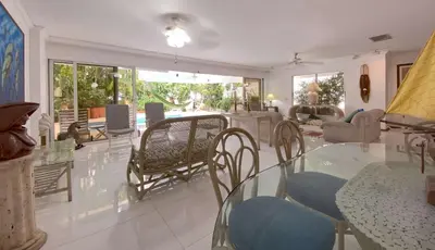 a living room with a glass table and chairs at Great Apartment With Private Pool in Cartagena de Indias