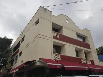 a building with red awnings on the side of it at Classic Loft in the Heart - El Prado in Barranquilla