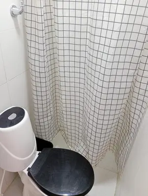 a bathroom with a toilet and a shower curtain at La Escalera de Getsemani in Cartagena de Indias