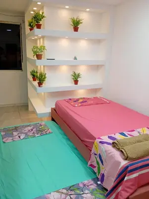 a bedroom with two beds and plants on shelves at La Escalera de Getsemani in Cartagena de Indias