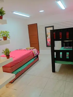 a room with a bed and a chair in it at La Escalera de Getsemani in Cartagena de Indias