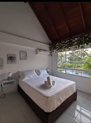a bedroom with a bed with a hat on it at Apartamento en Cielo Mar in Cartagena de Indias