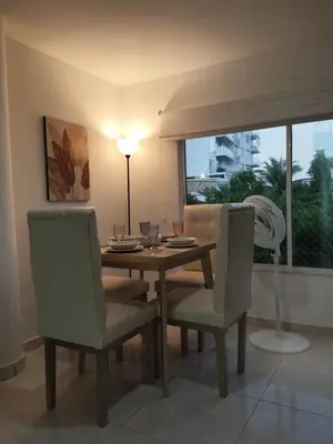 a dining room with a table and chairs and a window at Apartamento en Cielo Mar in Cartagena de Indias