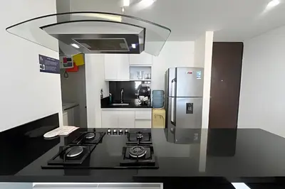 a kitchen with a stove and a refrigerator at Exclusivo apartamento vista al mar in Santa Marta