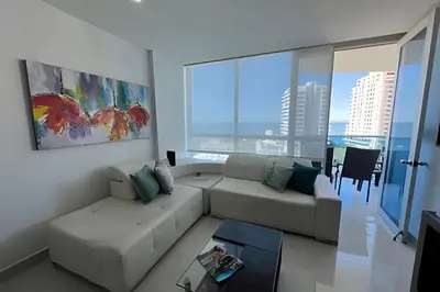 a living room with a couch and a large window at Exclusivo apartamento vista al mar in Santa Marta