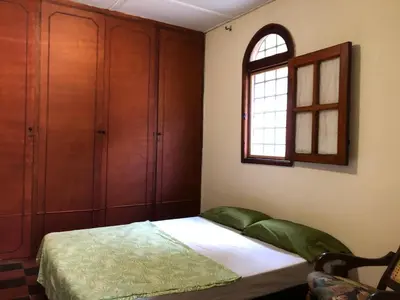 a bedroom with a bed and a window at Entire apartment bathroom AC Smart tv wifi kitchen in Barranquilla