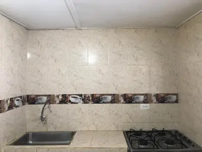 a kitchen with a sink and a counter with cups on a shelf at Entire apartment bathroom AC Smart tv wifi kitchen in Barranquilla