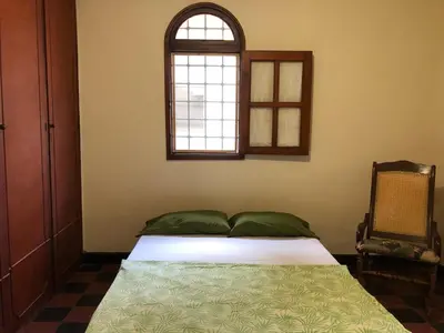 a bedroom with a bed and a window at Entire apartment bathroom AC Smart tv wifi kitchen in Barranquilla