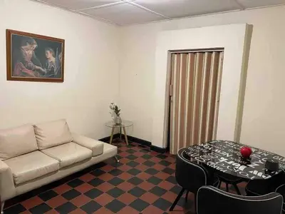 a living room with a couch and a table at Entire apartment bathroom AC Smart tv wifi kitchen in Barranquilla