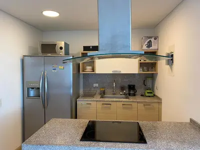 a kitchen with a refrigerator and a sink at Blue Gardens in Barranquilla