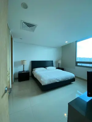 a bedroom with a bed with a blue light at Blue Gardens in Barranquilla