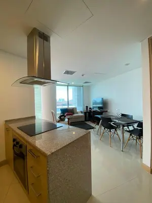 a kitchen and living room with a table and chairs at Blue Gardens in Barranquilla