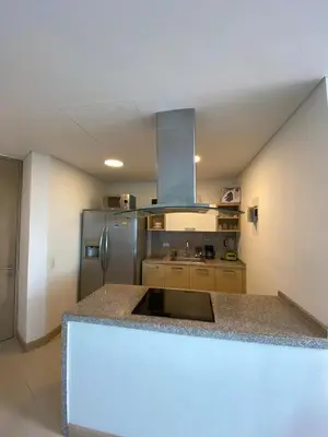 a kitchen with a counter top and a refrigerator at Blue Gardens in Barranquilla