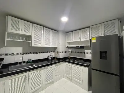 a kitchen with white cabinets and a stainless steel refrigerator at expetacular apartamento de 4 alcobas in Cartagena de Indias