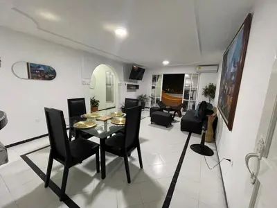 a dining room and living room with a table and chairs at expetacular apartamento de 4 alcobas in Cartagena de Indias