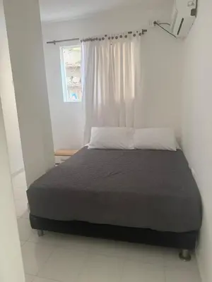 a bed in a white room with a window at expetacular apartamento de 4 alcobas in Cartagena de Indias