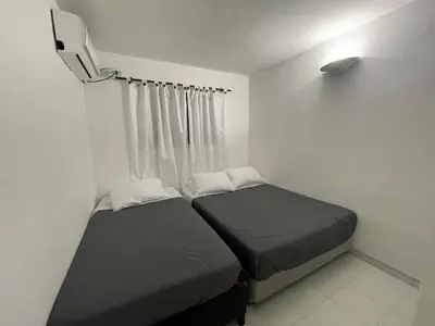 a small bedroom with two beds and a window at expetacular apartamento de 4 alcobas in Cartagena de Indias