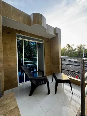 a patio with a bench and a table on a balcony at Orilla beach house in Playa Punta Arena