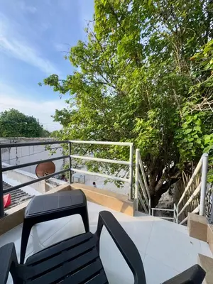 a table and chairs on a balcony with a view of the beach at Orilla beach house in Playa Punta Arena