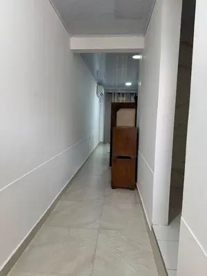 a long hallway with white walls and a door at Orilla beach house in Playa Punta Arena