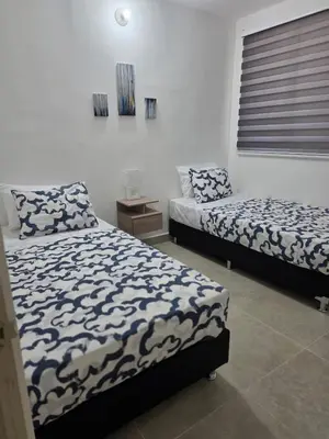 a bedroom with two beds and a night stand at Apartamento Cartagena Tranquilo playa-piscina in Manzanillo del Mar