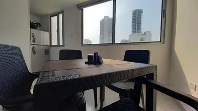 a conference room with a table with chairs and windows at 1401 Apartamento con AC, Piscina y Cerca Playa in Cartagena de Indias
