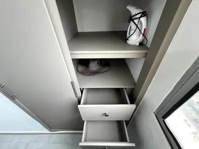 an attic room with white shelves and a staircase at 1401 Apartamento con AC, Piscina y Cerca Playa in Cartagena de Indias