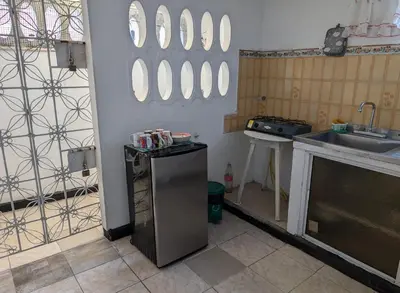 a kitchen with a sink and mirrors on the wall at Central Point Air BAQ in Barranquilla