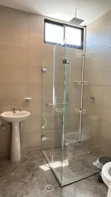a bathroom with a glass shower and a sink at Sofia del Mar in Puerto Colombia
