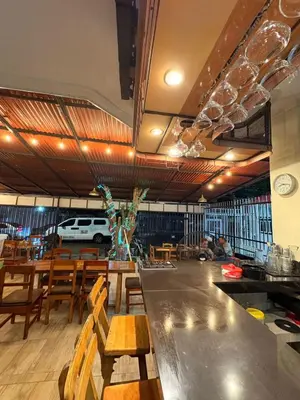 a restaurant with a long table and wooden chairs at Apartasuite Marbella in Cartagena de Indias