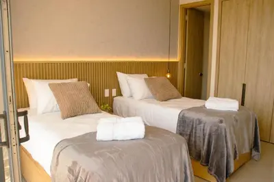 a hotel room with two beds with towels on them at Morros Serena del Mar in Cartagena de Indias