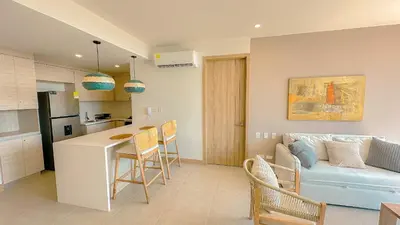 a kitchen and a living room with a couch at Morros Serena del Mar in Cartagena de Indias