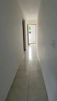an empty hallway with white walls and a tile floor at Apartamento Yulenis Coveñas in Guayabal