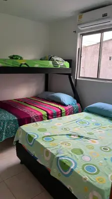 a bedroom with two beds and a bed with a comforter at Apartamento Yulenis Coveñas in Guayabal