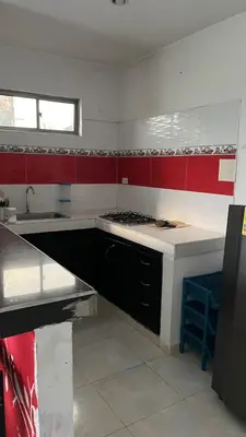 a kitchen with red and white walls and a sink at Apartamento Yulenis Coveñas in Guayabal