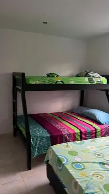 a bedroom with two bunk beds and a bed at Apartamento Yulenis Coveñas in Guayabal